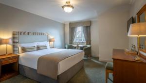 En eller flere senger på et rom på Bracken Court Hotel