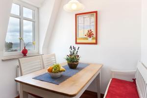 a dining room table with a bowl of fruit on it at Mal-Düne in Binz