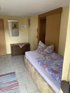 a bedroom with a bed and a dresser in it at Haus Schuster in Bad Salzschlirf