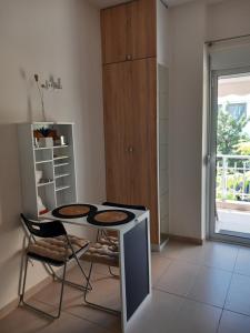a kitchen with a table and chairs in a room at Hra in Loutraki