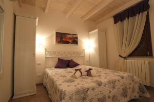 a bedroom with a bed with two shoes on it at Borgo della Luna in Birgi Vecchi