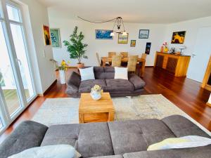 a living room with a couch and a table at Mal-Düne in Binz