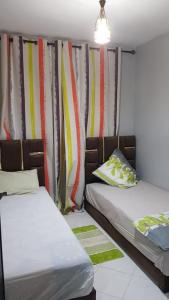 Ένα ή περισσότερα κρεβάτια σε δωμάτιο στο Appartement entier Familial Tamaris-Dar Bouazza-Casablanca