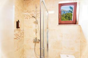 a bathroom with a shower with a toilet and a window at Cedrus Bran Boutique in Bran +25 photos