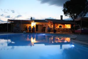 a swimming pool in front of a house at night at studio pour personne en déplacement in Issel