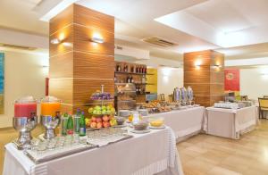 a buffet line with fruit and drinks in a restaurant at Virgilio Grand Hotel in Sperlonga