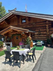 a table and chairs in front of a log cabin at Rösslwirtin Appartement in Innsbruck