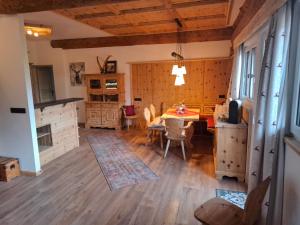 a kitchen and dining room with a table and a fireplace at Rösslwirtin Appartement in Innsbruck