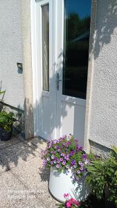 a white door with a bunch of flowers in front of it at Casa Germana in Invorio Inferiore +27 photos