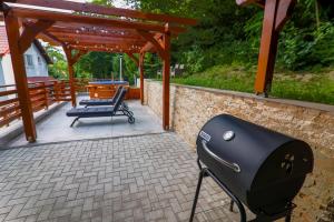a barbecue grill on a patio with a pavilion at Cedrus Bran Boutique in Bran