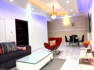a living room with a couch and a table at The Niche Homes & Apartments in Ikoyi