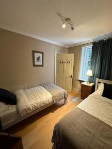 a bedroom with two beds and a window at Loch Lomond 2 Bedroom Apartment in Tarbet