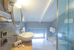 a bathroom with a sink and a glass shower at Virgilio Grand Hotel in Sperlonga