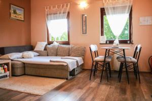 a living room with a couch and a table and two chairs at Guest house Studio apartman Marina - with jacuzzi, free parking, pet friendly in Karlovac +46 photos