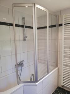 a shower in a bathroom with a glass door at Hyggelig in Kosel +20 photos