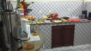 a kitchen with a counter with some food on a table at Panorama Hotel in Belém +17 photos