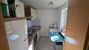 a small kitchen with a sink and a counter at Ferienwohnung Sonja in Westerende