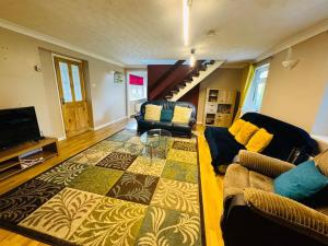 a living room with a couch and a table at Contractors families free parking Ramsey Road in St Ives