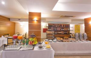 a buffet line with food and drinks in a restaurant at Virgilio Grand Hotel in Sperlonga