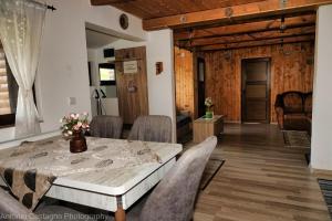 a dining room with a table and chairs at Cabana Fodora in Fodora