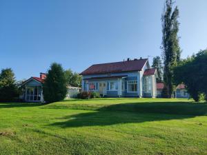 a house with a large yard in front of it at Tuulas in Sotkamo