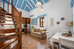 a living room with a table and a couch at Villa Ftenagia in Halki