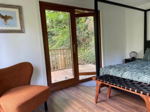 a bedroom with a bed and a sliding glass door at Kestrel lodge in Wrexham