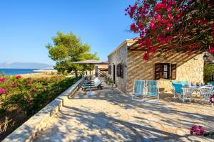 a stone house with a view of the ocean at Villa Ftenagia in Halki +22 photos