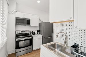 a kitchen with a sink and a stove top oven at Unit # 1 - Right Next to Howard University in Washington