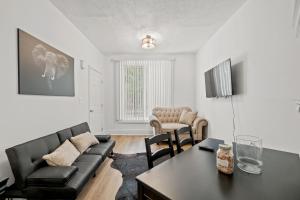 a living room with a couch and a table at Unit # 1 - Right Next to Howard University in Washington