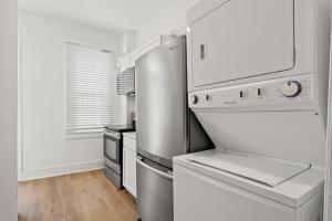 a kitchen with white appliances and a refrigerator at Unit # 1 - Right Next to Howard University in Washington