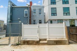 a white fence in front of a building at Unit # 1 - Right Next to Howard University in Washington