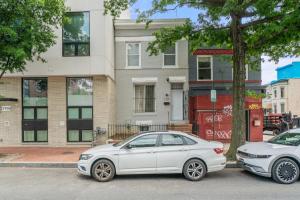 two white cars parked in front of a building at Unit # 1 - Right Next to Howard University in Washington