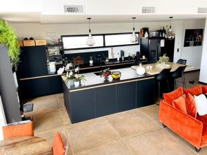 a kitchen with an island with a counter top at Villa 7 in Martillac
