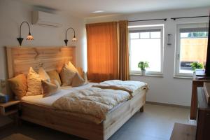 a bedroom with a large bed and a window at Ferienwohnung BERGWELTEN in Oberaudorf