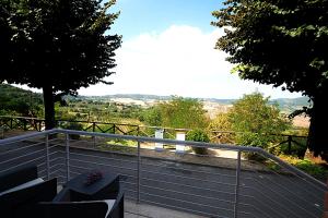 a balcony with benches and a view of the countryside at Casa Lulù in Montepulciano