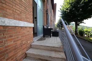 a metal railing on a brick building with stairs at Casa Lulù in Montepulciano +15 photos