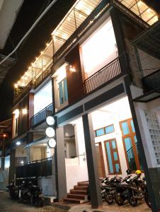 a building with motorcycles parked in front of it at Ador 46 Homestay Syariah & Kost in Mergan