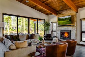 a living room with a couch and a fireplace at 5 King Beds! Golf Course View on Huge Shaded Deck in Cle Elum