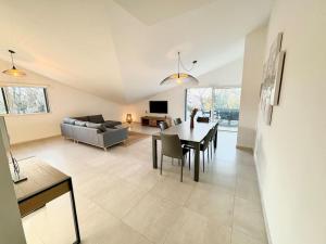 a living room with a table and a couch at Appartement 3 chambres, piscine, 50 m des plages in Les Lecques