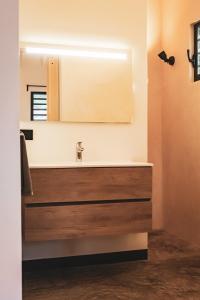a bathroom with a sink and a mirror at Villa 5 Green Courtyard Village in Kralendijk
