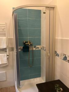 a shower with a glass door in a bathroom at Casa Rosa in Palermo +58 photos