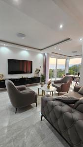a living room with couches and a flat screen tv at Sisters residence in Kotor