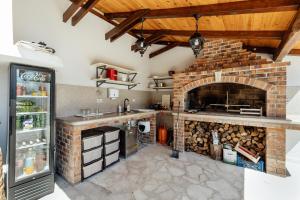 a kitchen with a brick fireplace and a stove at Villa Goranovic in Herceg-Novi