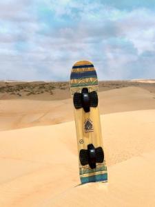 a skateboard in the sand in the desert at Infinity Camp in Bidiyah