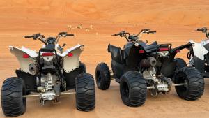two atvs and a quad bike in the desert at Infinity Camp in Bidiyah