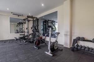 a gym with several treadmills and exercise bikes at Bali Bustle Sunset Coliving and Coworking Space in Legian