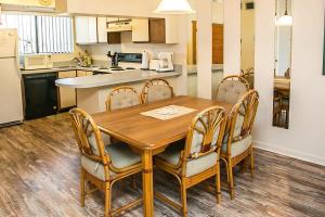 a kitchen and dining room with a wooden table and chairs at Unwind at St Augustine's Beachfront Oasis in Saint Augustine