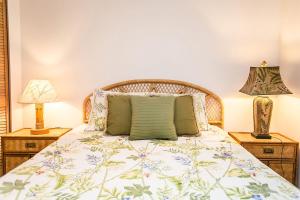 a bedroom with a bed with two night stands at Hibiscus H204 in St. Augustine