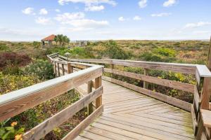 a wooden boardwalk leading to the beach at Hibiscus H204 in St. Augustine